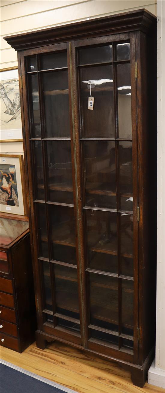 A 19th century brass mounted glazed oak narrow two door bookcase W.92cm